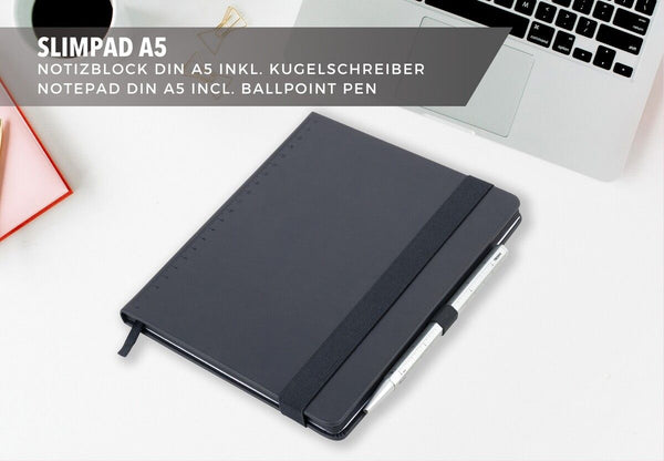 Black Troika notebook with silver  pen on a white surface, with text about Slimpad A5 notepad and ballpoint pen.