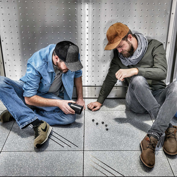 Troika Wurfel To Go Dice Cup with Storage Compartment with Five Dice, Item GAM60/BK Showing Two Men Using the Dice Cup and Dice